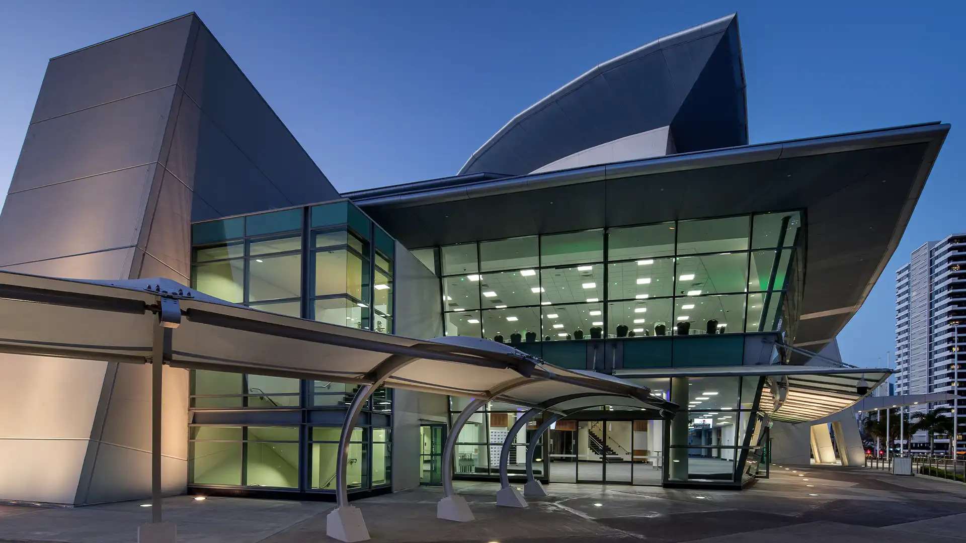 Gold Coast entertainment at the Broadbeach Convention and Exhibition Centre, modern glass exterior at dusk.